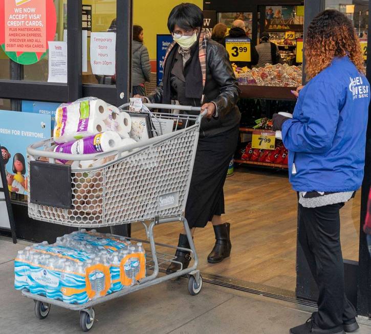 Terry Arthur, 71, of Las Vegas, exits with the limited amount of water and toilet paper per hou ...