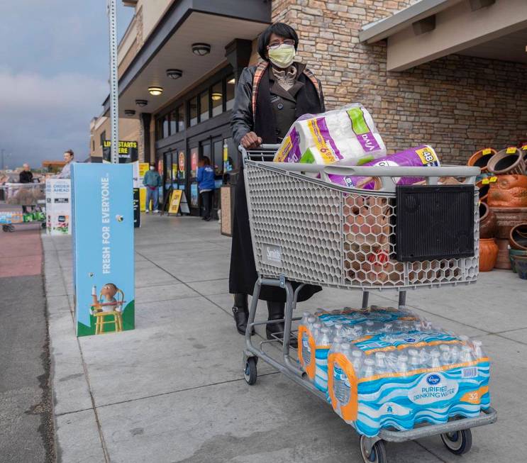 Terry Arthur, 71, of Las Vegas, exits with the limited amount of water and toilet paper per hou ...