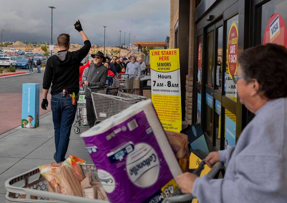 Instructions on limited items are given to the line of seniors out of a Smith's Marketplace loc ...