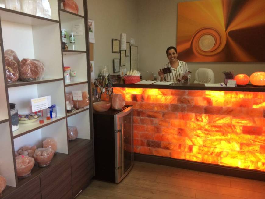 Ava Mucikyan, conducts business behind a Himalayan salt rock counter Nov. 1, 2017, while talkin ...