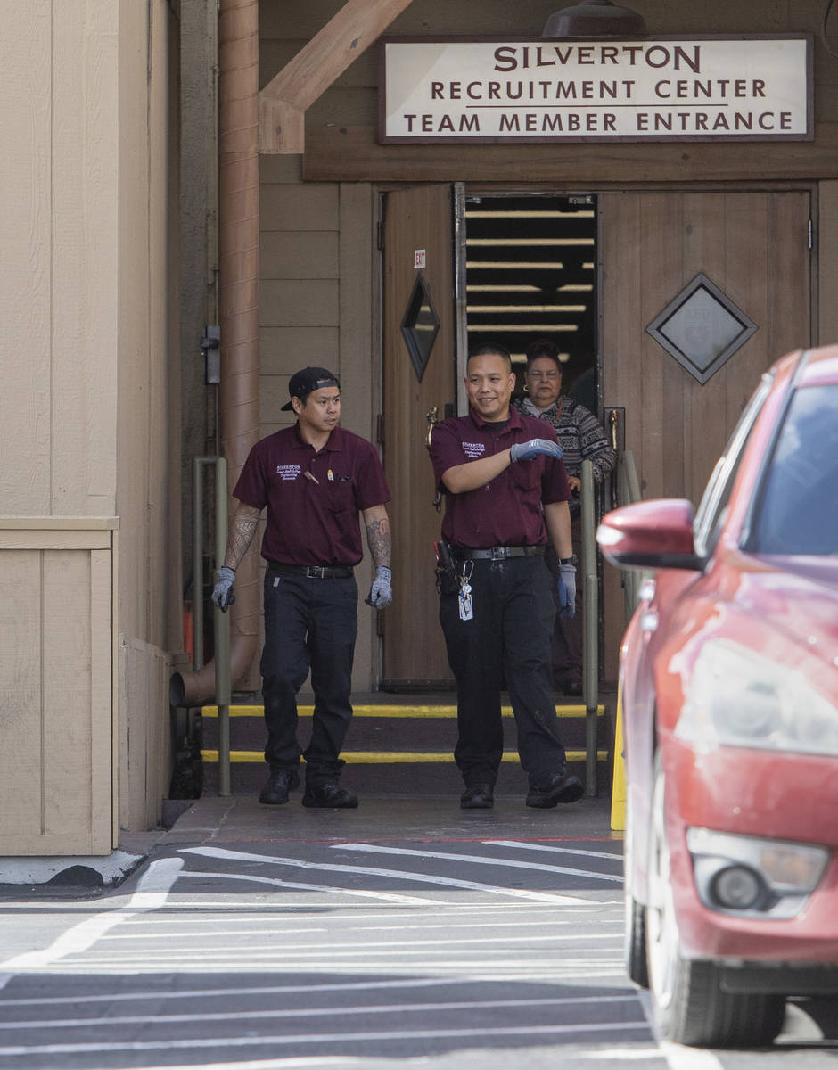Employees exit Silverton Casino into the team member parking lot on Friday, March 20, 2020, in ...