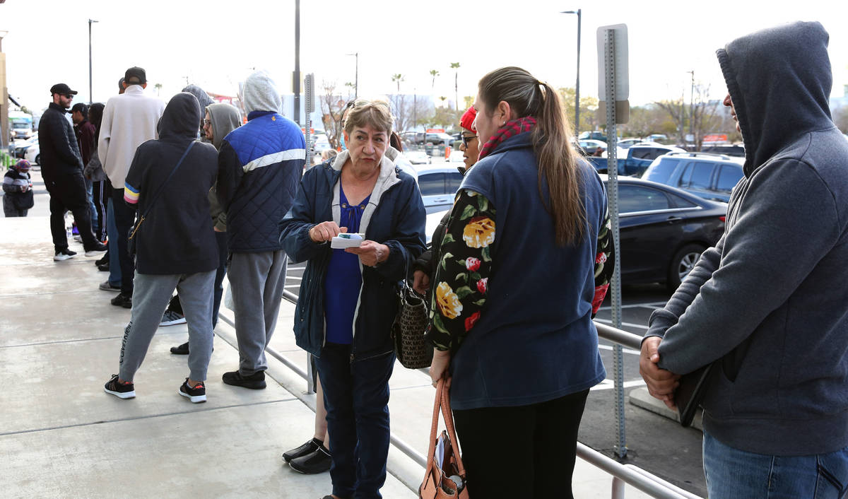 People wait in line at One-Stop Career Center on Tuesday, March 17, 2020, in Las Vegas. The loc ...