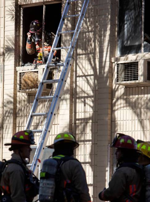 Las Vegas Fire Department firefighters assess the damage after structure fire was put out at 32 ...