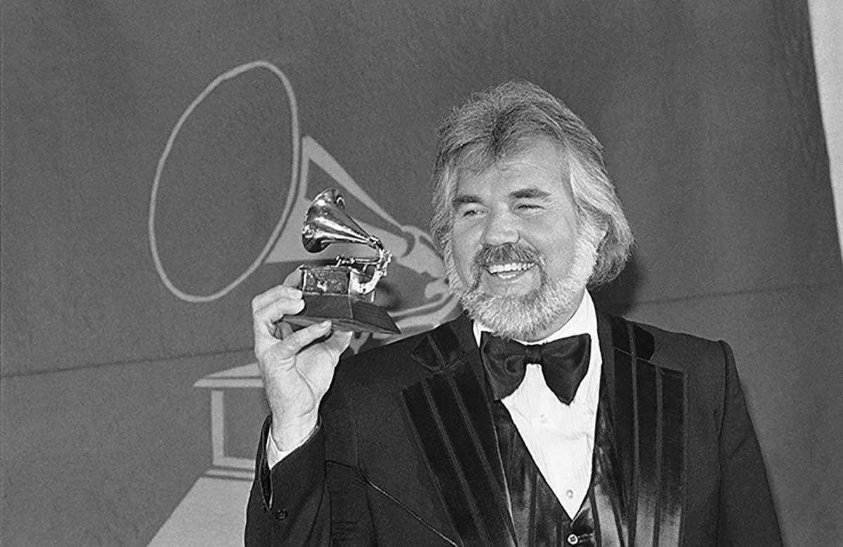 In this Feb. 28, 1980 file photo, Kenny Rogers holds a Grammy Award he received during presenta ...