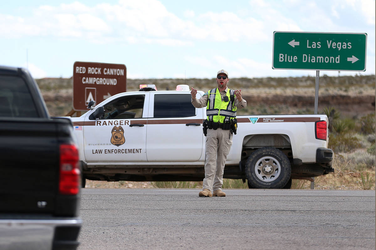 A park ranger controls traffic on Route 159 at Red Rock Canyon in Las Vegas, Saturday, March 21 ...