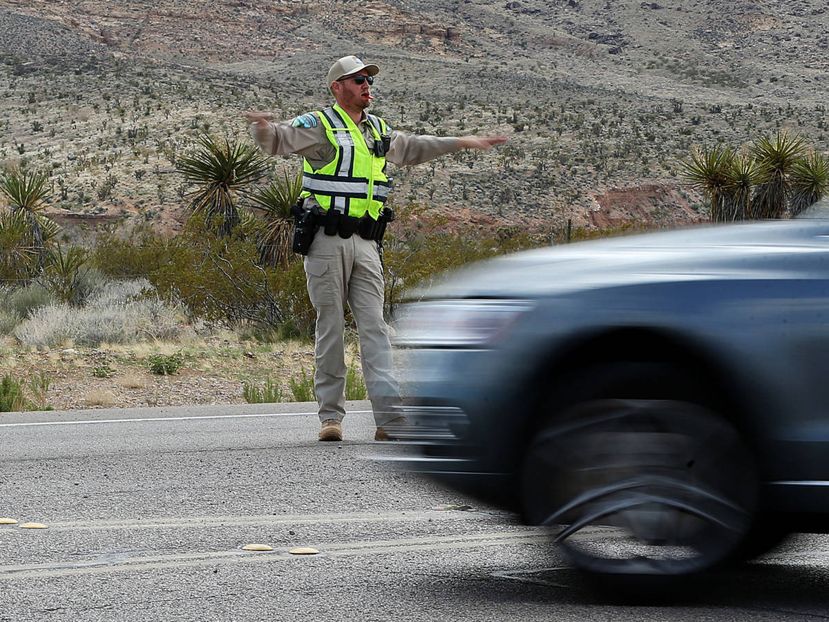 A park ranger controls traffic on Route 159 at Red Rock Canyon in Las Vegas, Saturday, March 21 ...