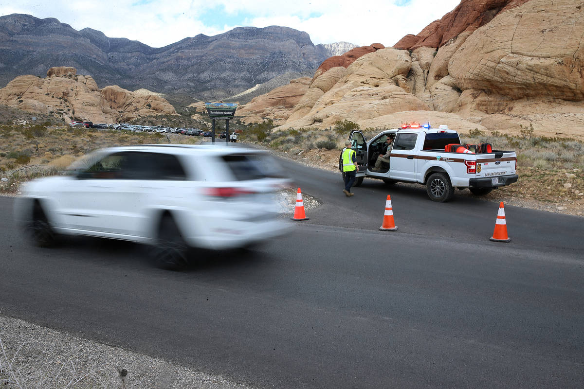 A park ranger closes off the Sandstone Quarry trail at the Red Rock Canyon scenic loop in Las V ...