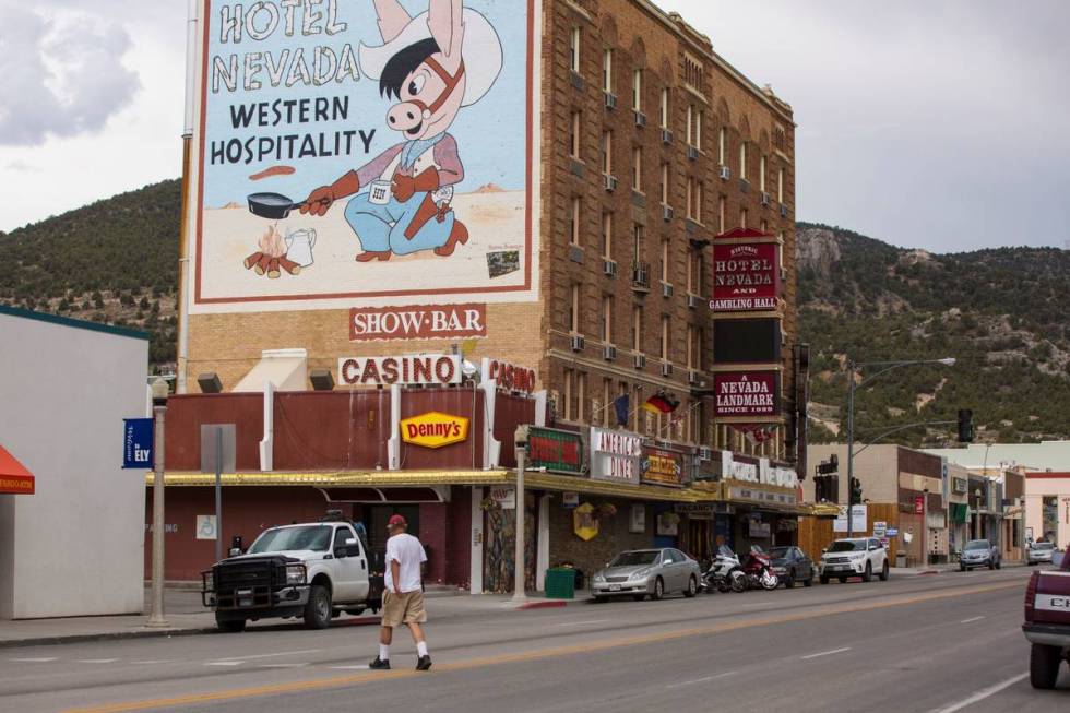 A man walks across Aultman Street, the main road through Ely, near Hotel Nevada In July 2018. ( ...