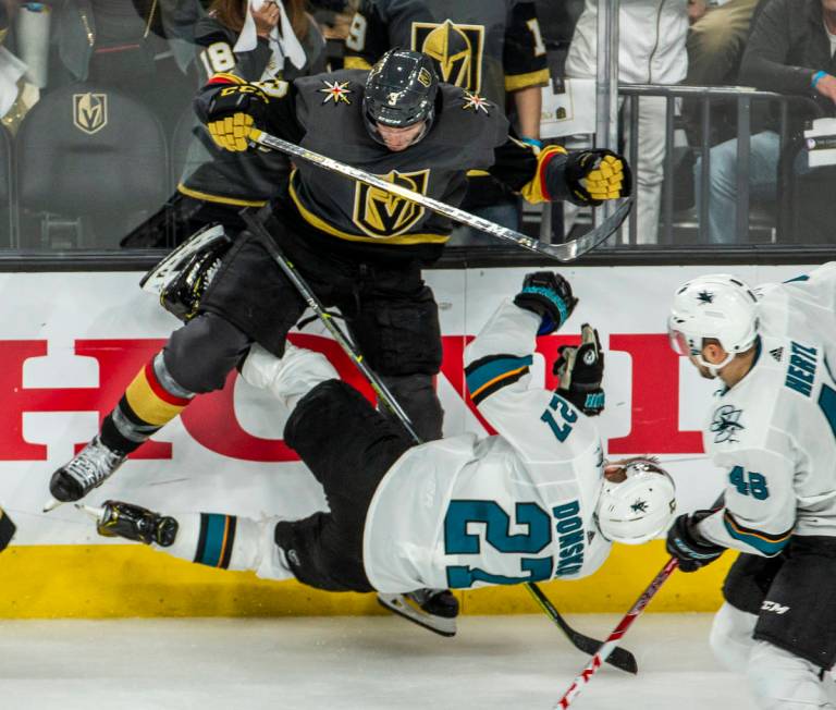 Golden Knights defenseman Brayden McNabb (3) puts a big hit on San Jose Sharks right wing Joona ...