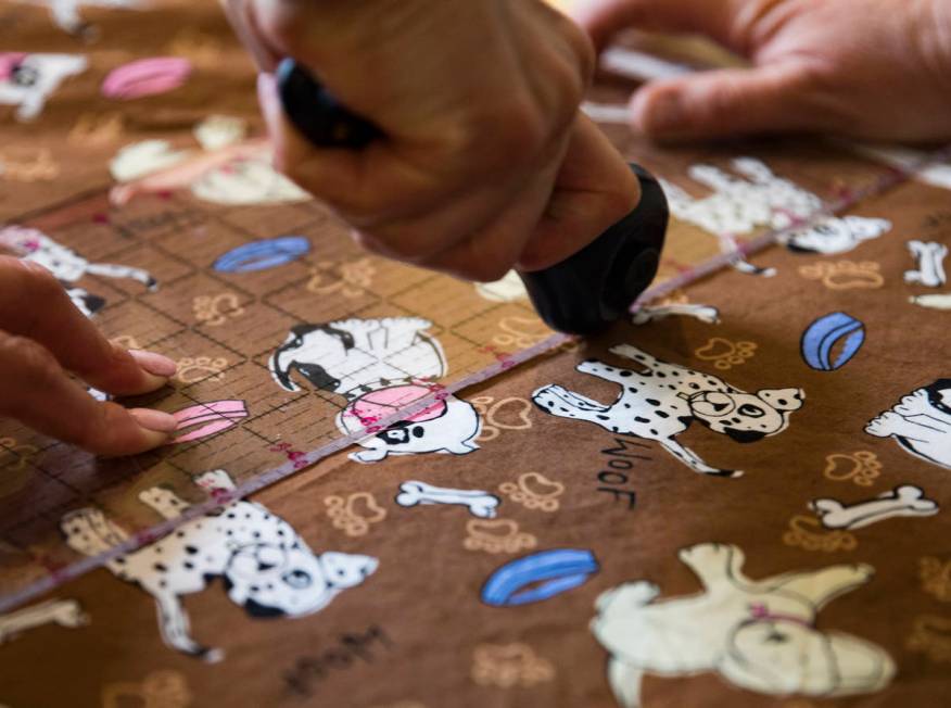 Terri Yannone cuts fabric at her friend Anissa Gustafsonͳ home in Las Vegas, Sunday, Marc ...