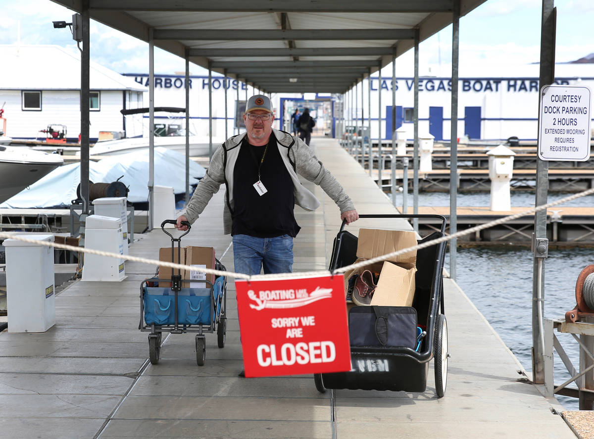 Richard Keeley of Henderson pushes his belongings that were retrieved from his boat at Lake Las ...