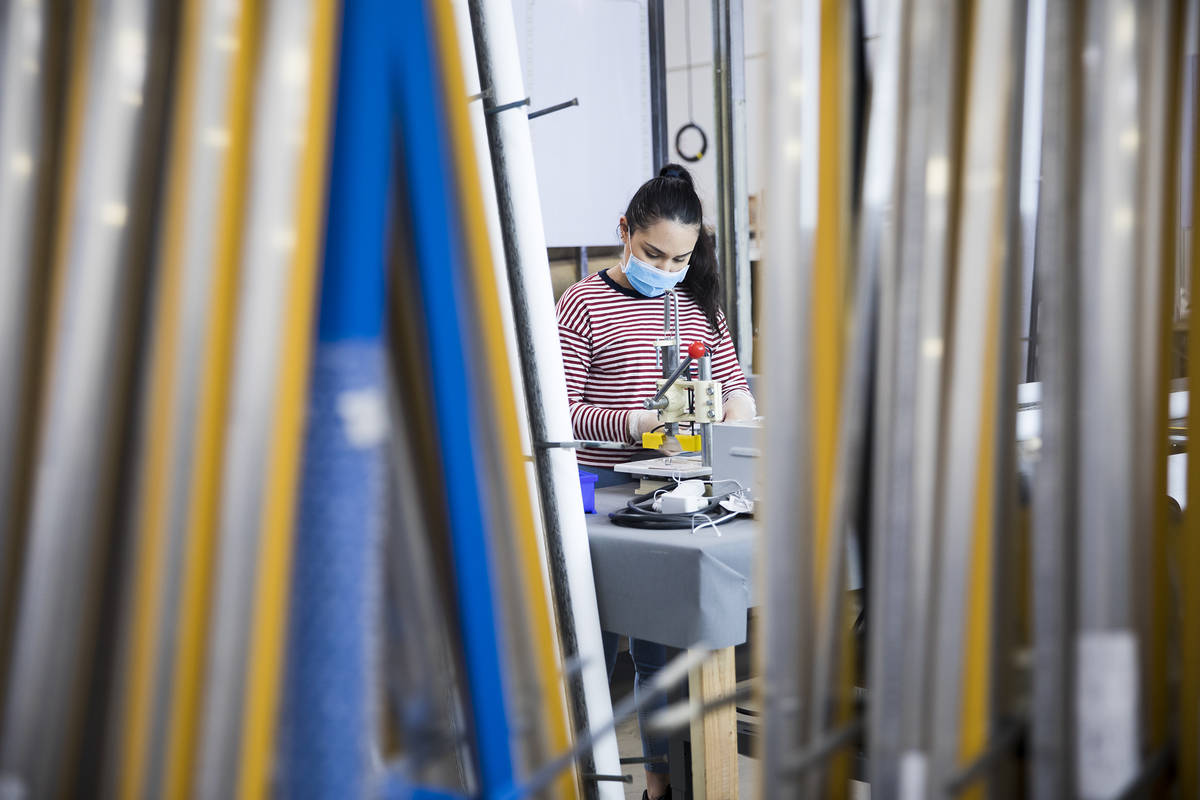 Annie Duenez seams the fabric of a roller shade at Polar Shades in Las Vegas, Monday, March 23, ...