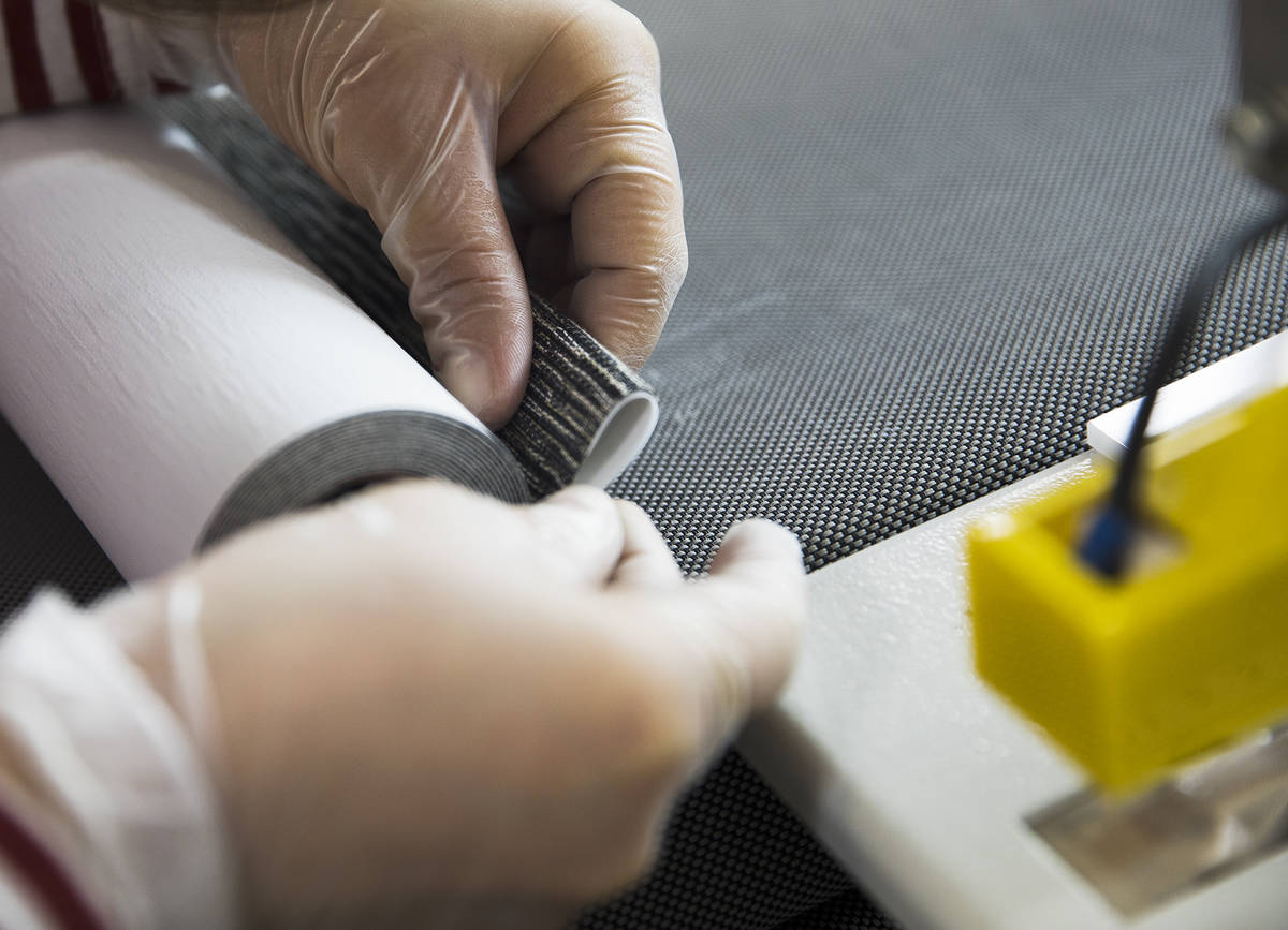 Annie Duenez seams the fabric of a roller shade at Polar Shades in Las Vegas, Monday, March 23, ...