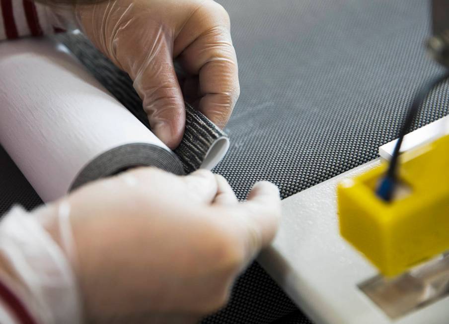 Annie Duenez seams the fabric of a roller shade at Polar Shades in Las Vegas, Monday, March 23, ...