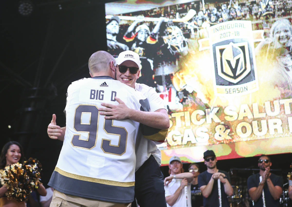 Golden Knights defender Nate Schmidt hugs broadcaster Wayne "Big D" Danielson during the Golden ...