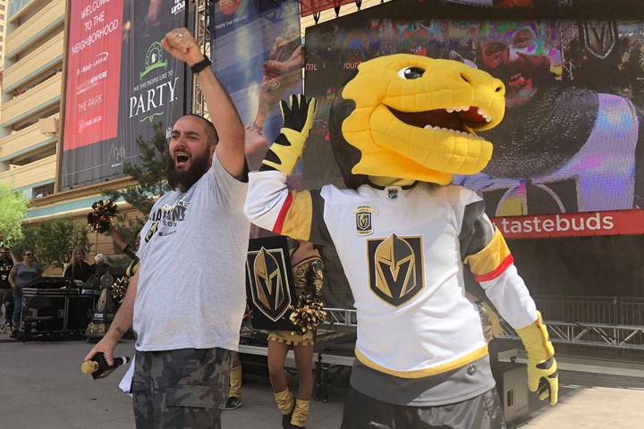 Wayne "Big D" Danielson and Chance the gila monster celebrate the Vegas Golden Knights 2-1 vict ...