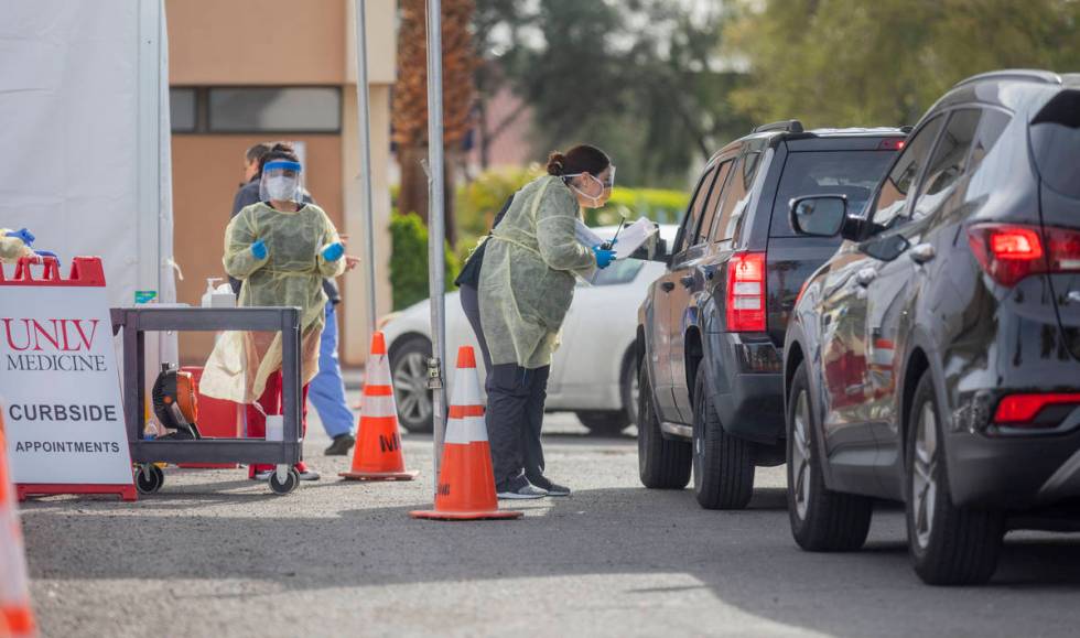 UNLV medicine medical professionals conduct curbside testing on patients experiencing coronavir ...