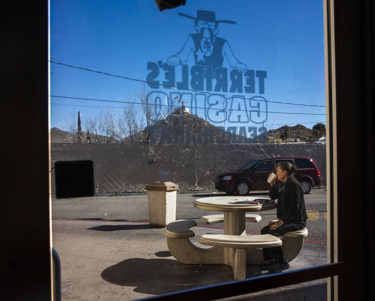 A customer enjoys some coffee and a smoke outside of the Terrible's Casino gas station on Tuesd ...