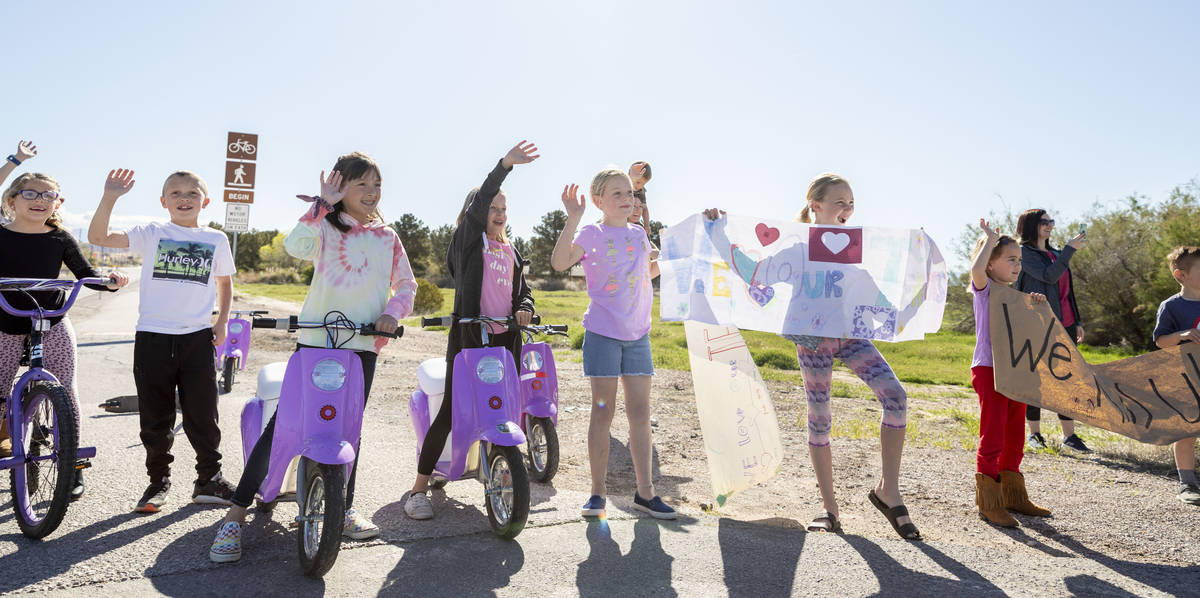 Grant M. Bowler elementary students wave to their teachers during a teacher parade in Logandale ...