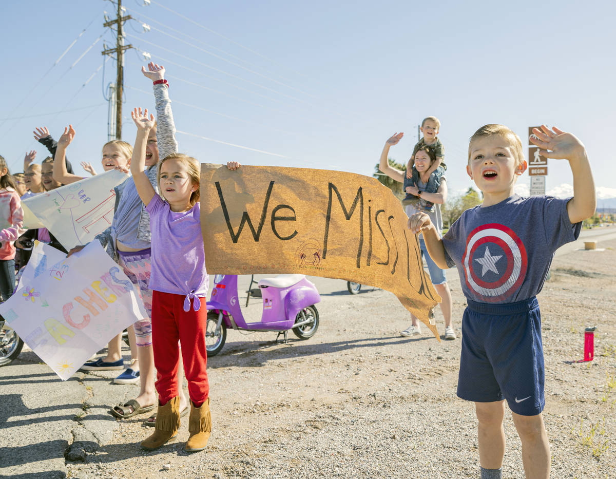 Grant M. Bowler elementary students wave to their teachers during a teacher parade in Logandale ...