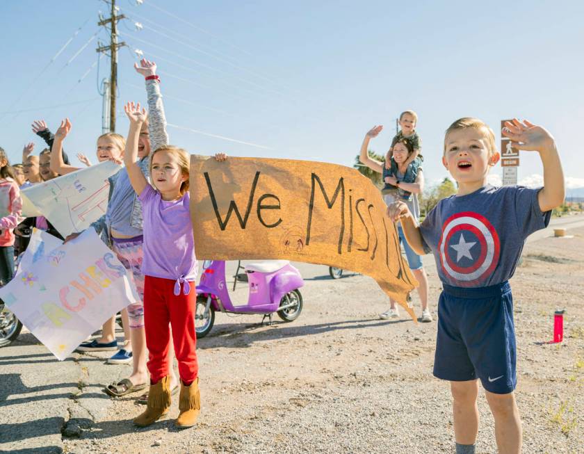 Grant M. Bowler elementary students wave to their teachers during a teacher parade in Logandale ...