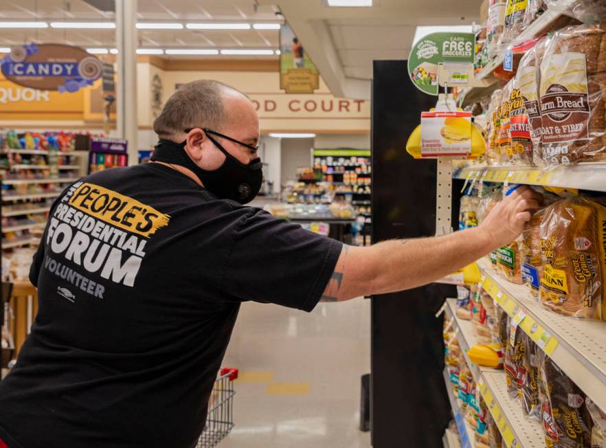 Trinity Tanner, 43, of Overton, gets bread at Lin's Market in Overton on Tuesday, March 24, 202 ...