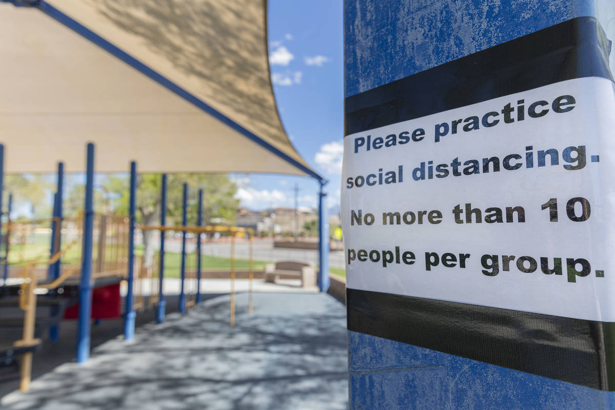 A sign asking for social distancing is seen at a playground in Veteran's Memorial Park in Mesqu ...