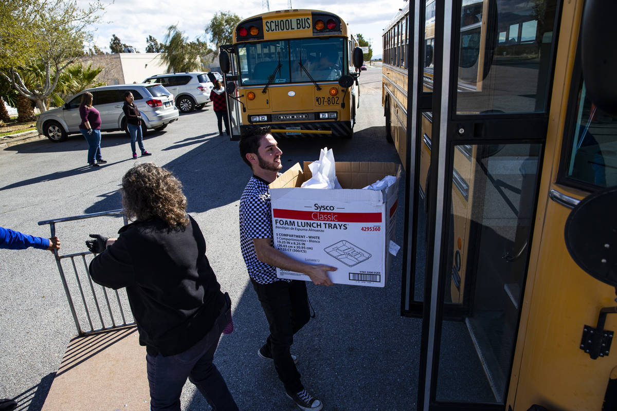 Javier Favela helps load school meals to be distributed to local students at home in Amargosa V ...