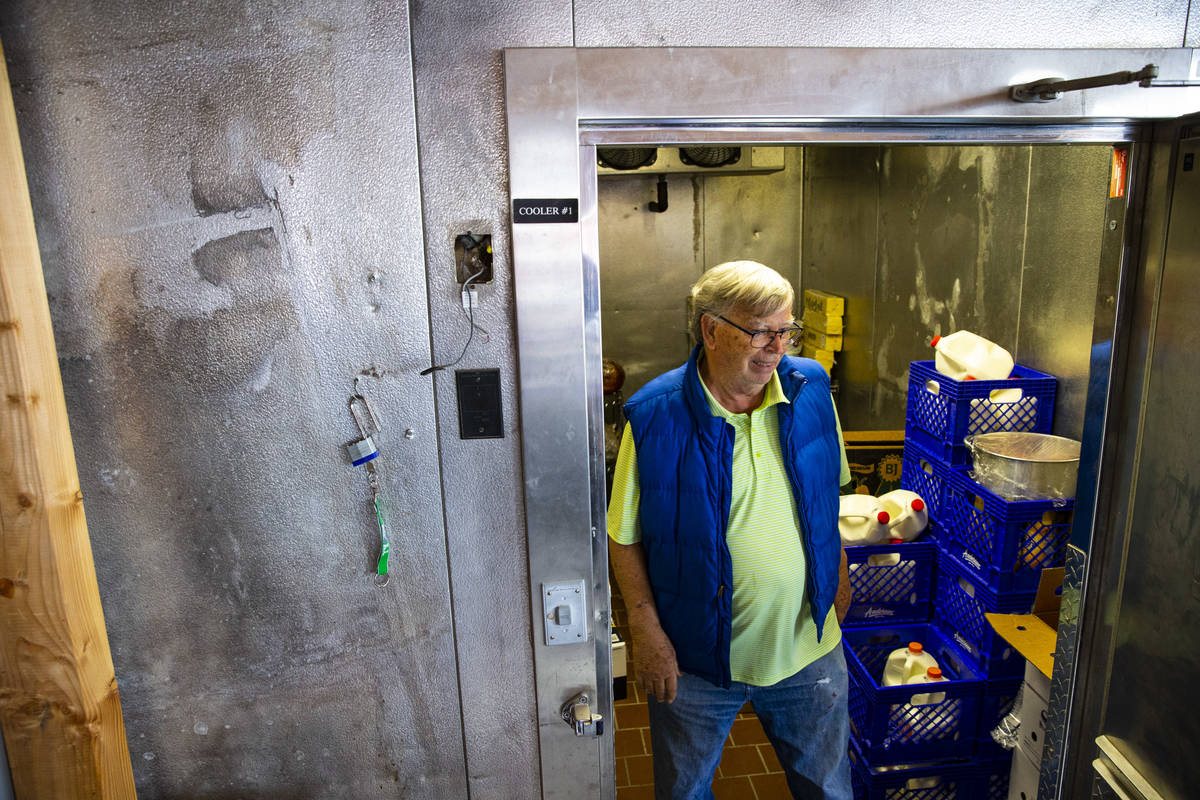 Ed Martell, owner of Martell Market, walks through a refrigerator full of stocked goods in Amar ...