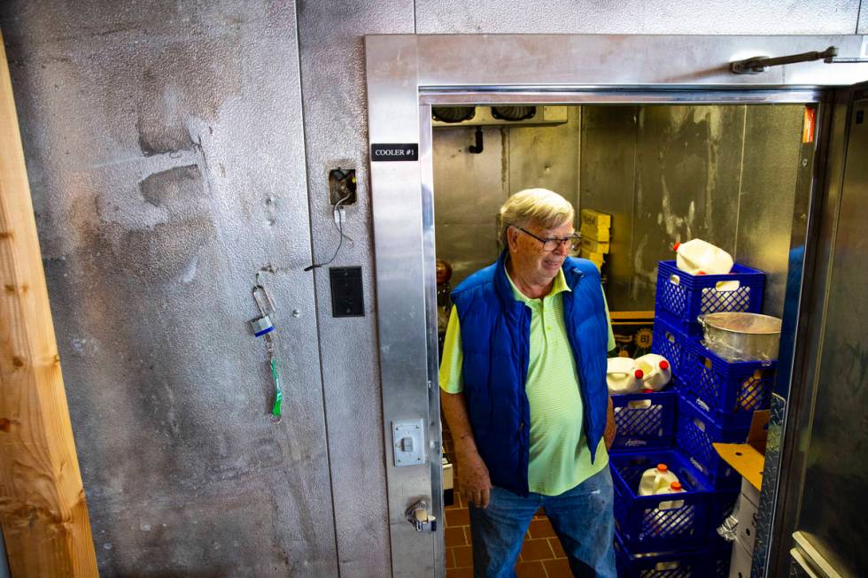 Ed Martell, owner of Martell Market, walks through a refrigerator full of stocked goods in Amar ...