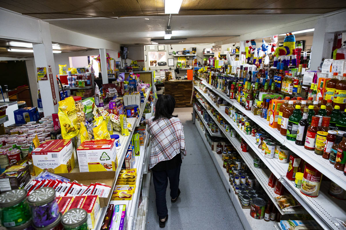 Sunny Martell, owner of Martell Market, walks through an aisle full of items stocked at the mar ...