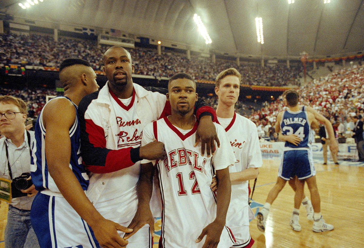 UNLV's Anderson Hunt (12) and unidentified teammates leave the floor after losing to Duke in th ...