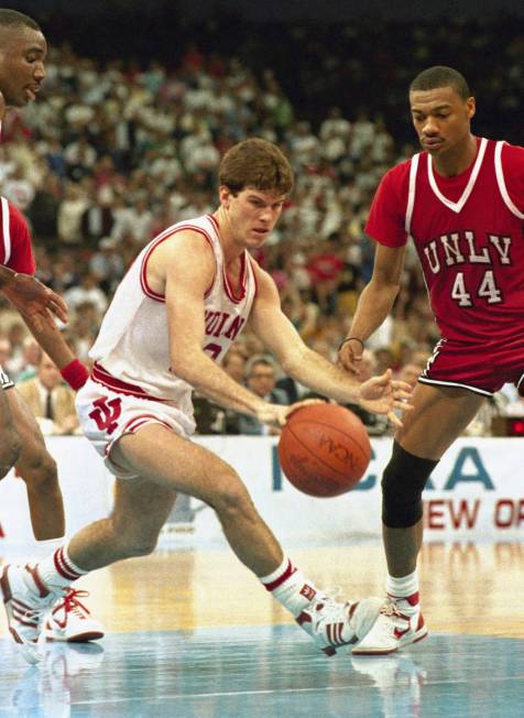 Indiana University's Steve Alford dribbles past University of Las Vegas's Jarvis Basnight as th ...