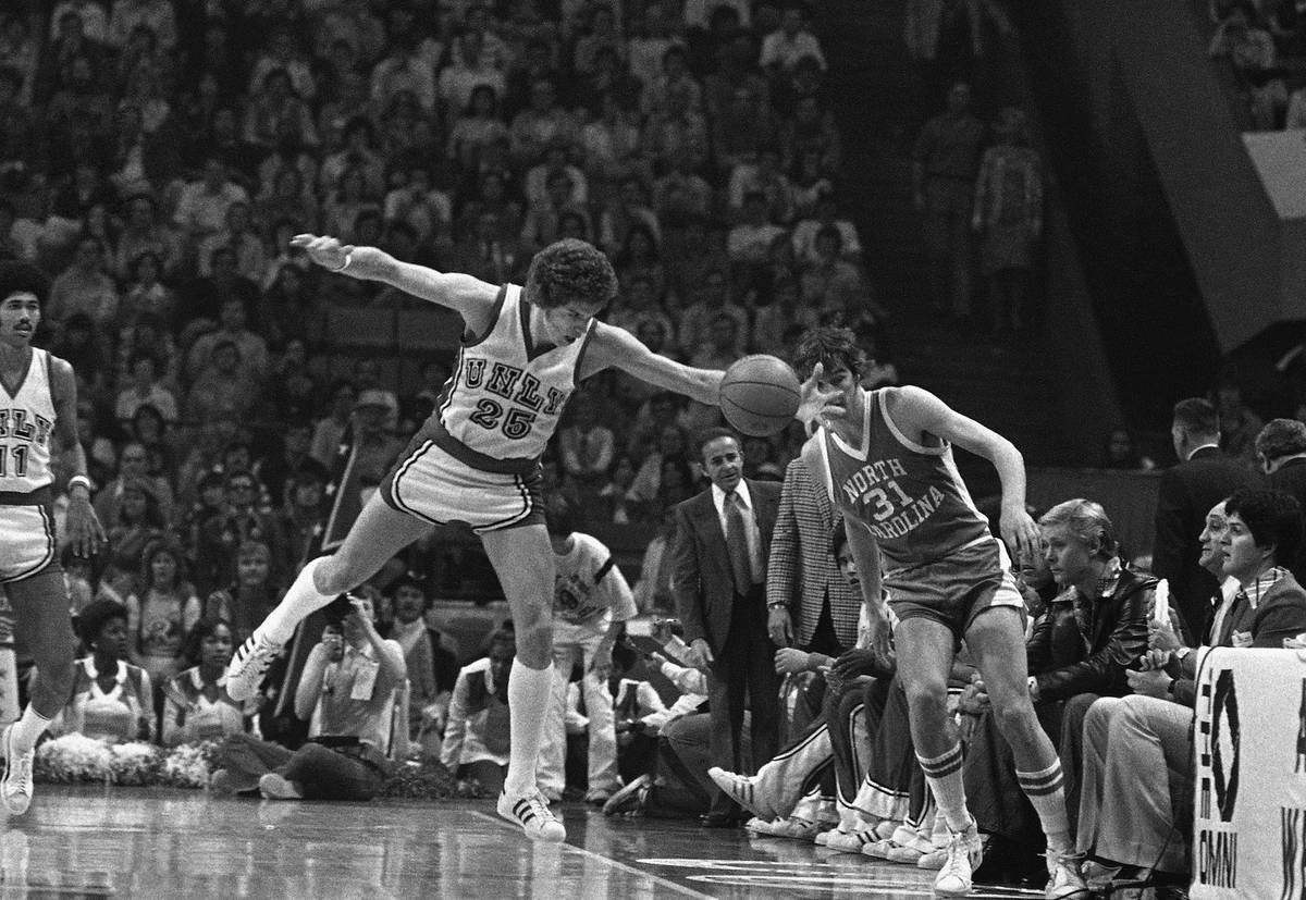 UNLV basketball player Glen Gondrezick (25), left, makes a long reach to save a ball headed out ...