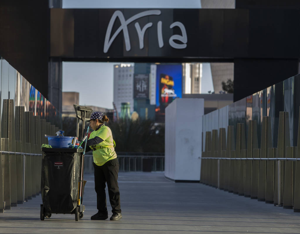 A maintenance employee cleans the pedestrian bridge between Aria and Cosmopolitan on the Strip ...