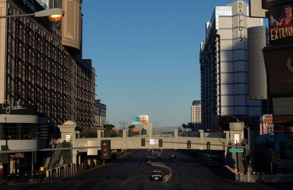 A police car drives north on Las Vegas Boulevard on Tuesday, March 24, 2020, in Las Vegas. (Ell ...