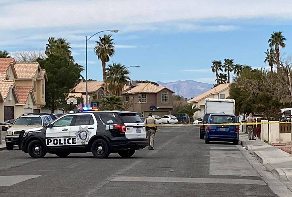 Las Vegas police officers at the scene of a fatal crash on Sloan Lane near East Charleston Boul ...