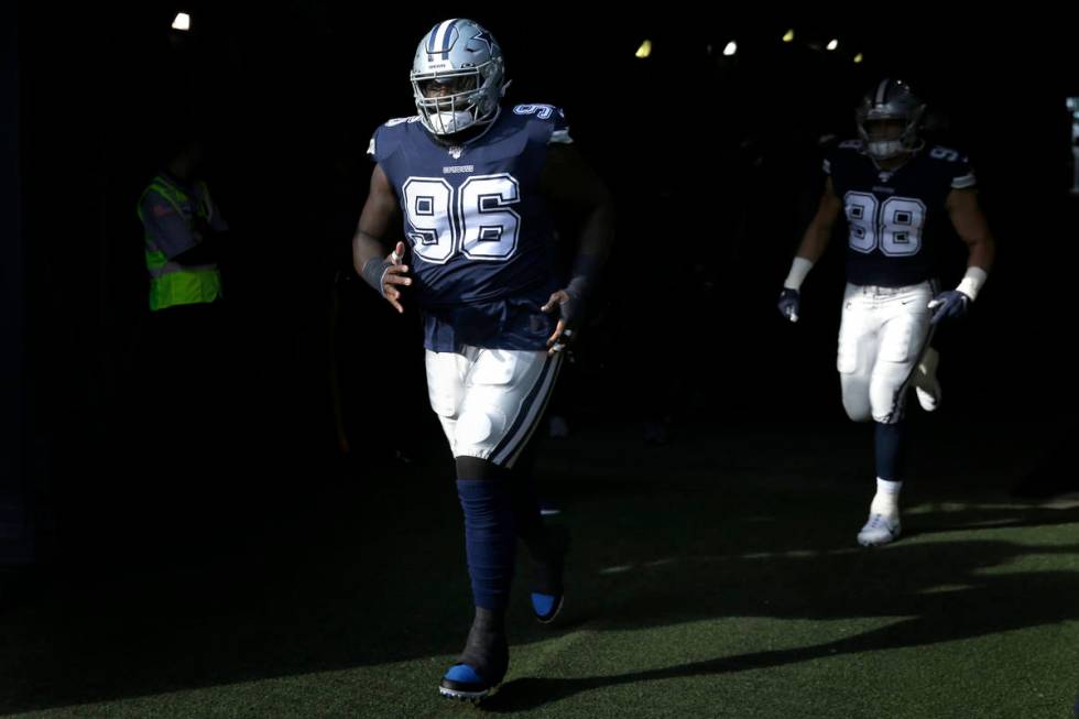 Dallas Cowboys' Maliek Collins runs onto the field before an NFL football game against the New ...