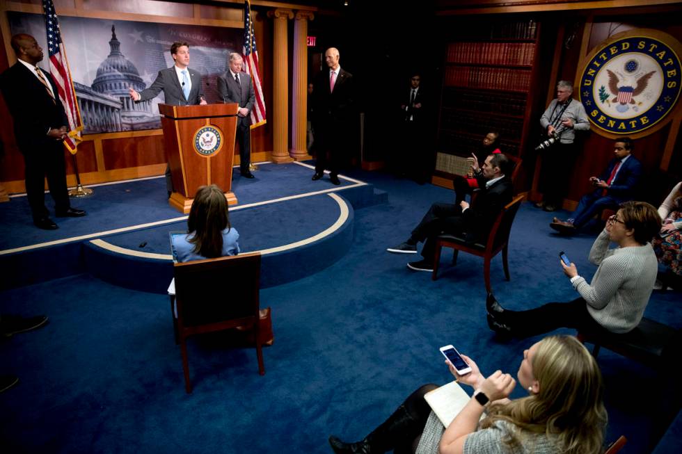 Sen. Ben Sasse, R-Neb., second from left, accompanied by Sen. Tim Scott, R-S.C., left, Sen. Ric ...