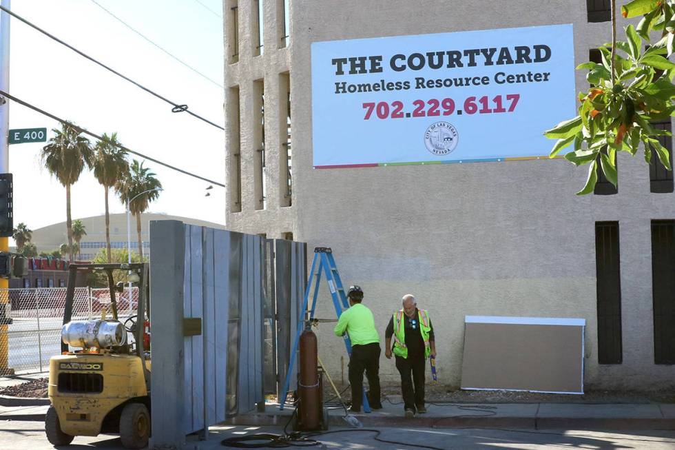 Workers install a gate at the corner of Las Vegas Boulevard and Foremaster Lane near the Courty ...