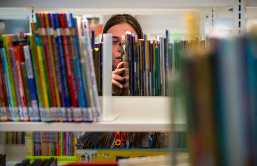 Rachel Hiatt shelves more kids books as work continues on the new East Las Vegas Library, one o ...