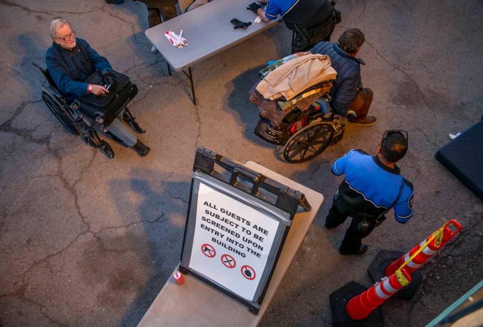 Men are directed to their mats for the night at the Courtyard Homeless Resource Center on Monda ...