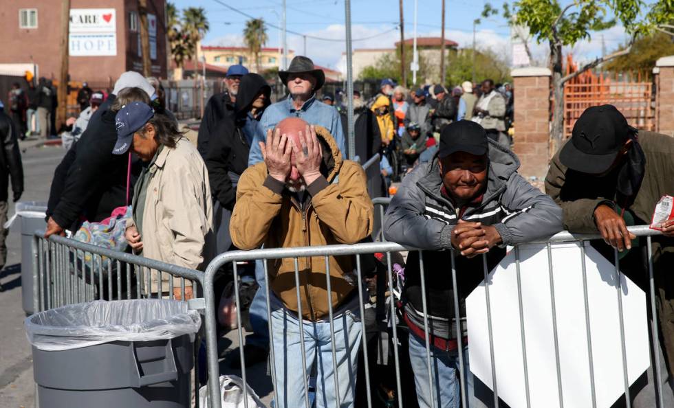 People, including from right, Jesus Howard, Nyima Tsering and Rob Thurston line up for to-go lu ...