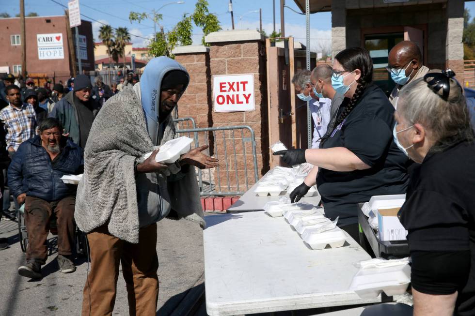 Michael Brown grabs a to-go lunches at Catholic Charities on Foremaster Lane in Las Vegas Thurs ...