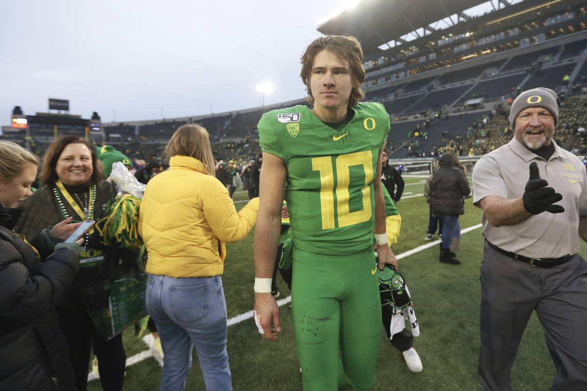 Oregon quarterback Justin Herbert (10) walks off field following an NCAA college football game ...