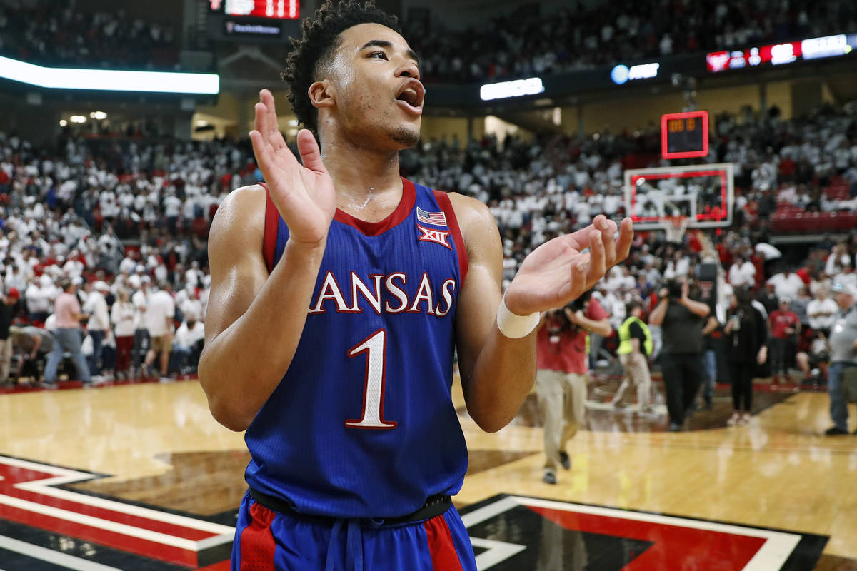FILE - In this March 7, 2020, file photo, Kansas' Devon Dotson (1) celebrates after an NCAA col ...