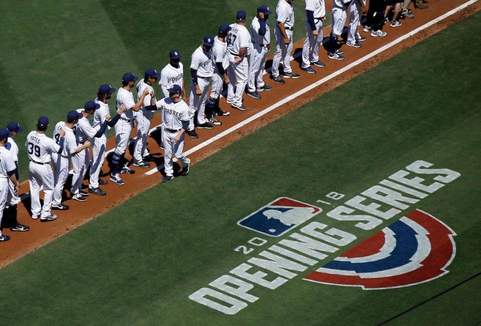 San Diego Padres manager Andy Green, center, greets his team after being introduced before an o ...