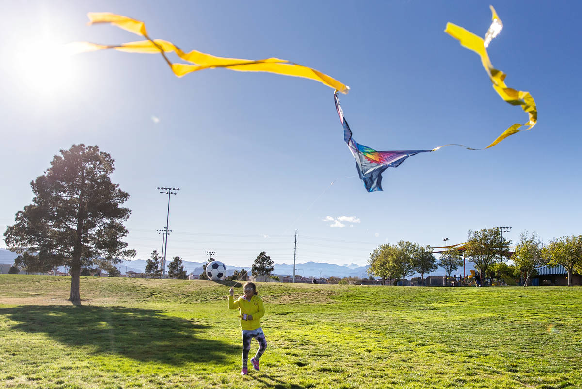 People take advantage of the open space at Desert Breeze Park flying kites on Friday, March 27, ...