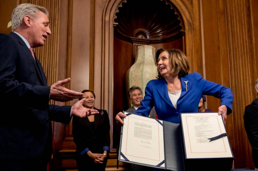 House Speaker Nancy Pelosi of Calif., right, speaks with House Minority Leader Kevin McCarthy o ...