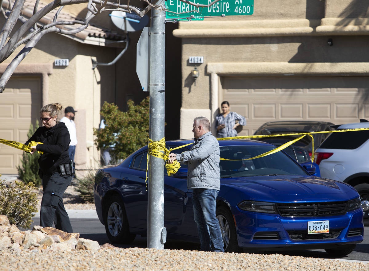 Las Vegas police take down crime scene tape after collecting evidence from the crime scene of a ...